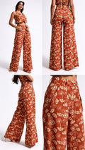 A woman modeling a rust-orange wide-leg jumpsuit with a cream floral print, shown in multiple views including front, back, side, and close-up detail shots on a white studio background.